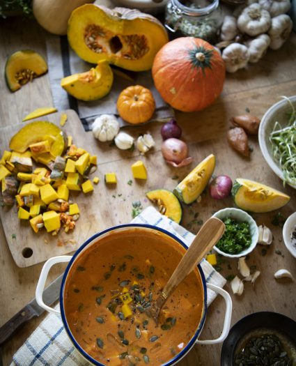Pot of pumpkin soup on a table